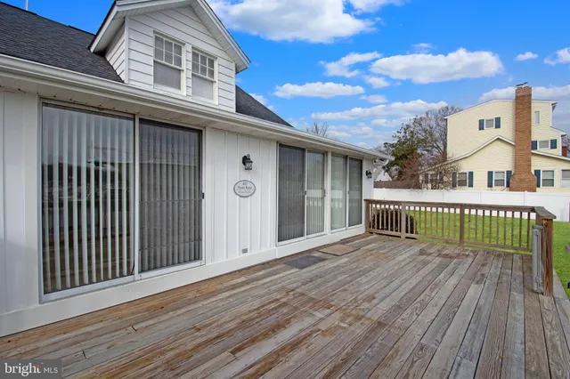 a view of a house with wooden deck