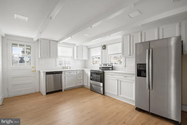 a kitchen with a refrigerator stove and sink