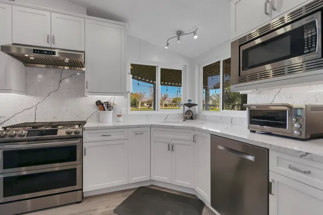 a view of a dining room with furniture large window and wooden floor
