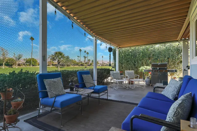 a living room with furniture fireplace and a large window