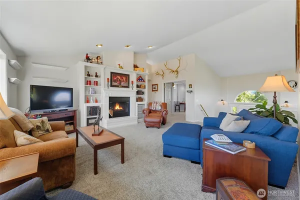 a living room with furniture a flat screen tv and a fireplace