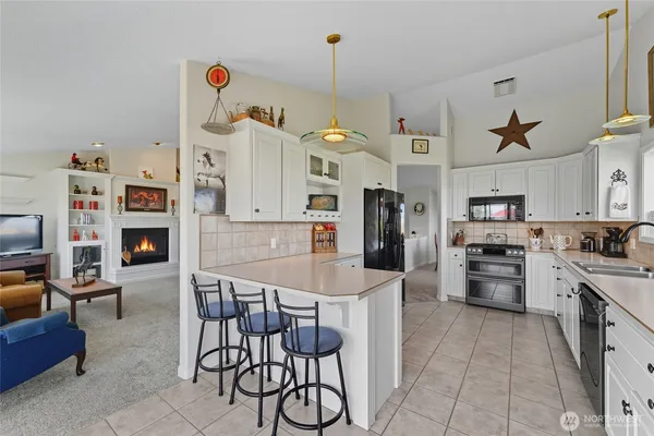 a kitchen with stainless steel appliances granite countertop a stove and a refrigerator