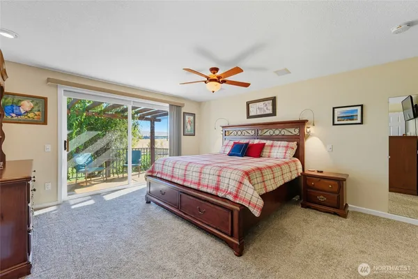 a bedroom with a bed and a large window