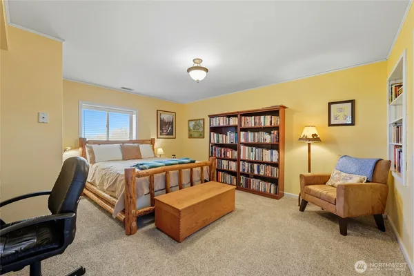 a bedroom with furniture and a book shelf