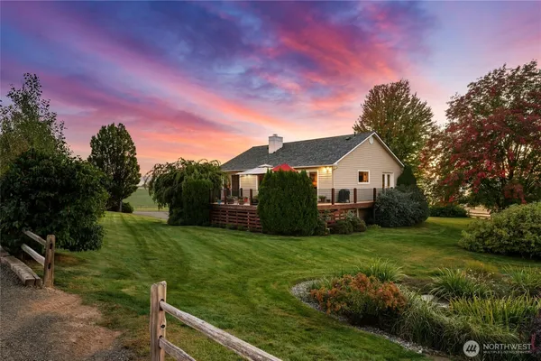 a front view of a house with yard and green space