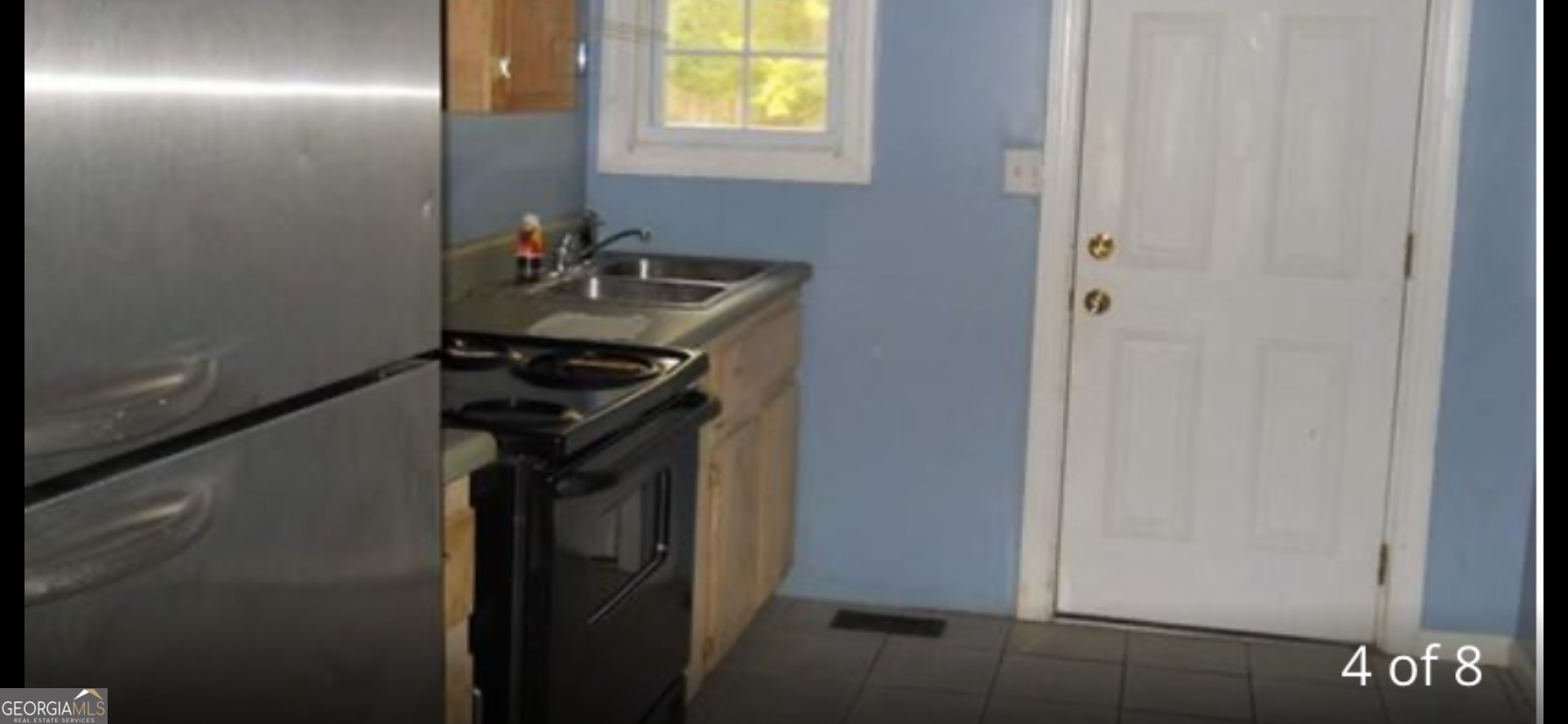 118 Tye Street Stockbridge, GA 30281 - Photo 4 of 12 a close view of a sink and a mirror next to a window