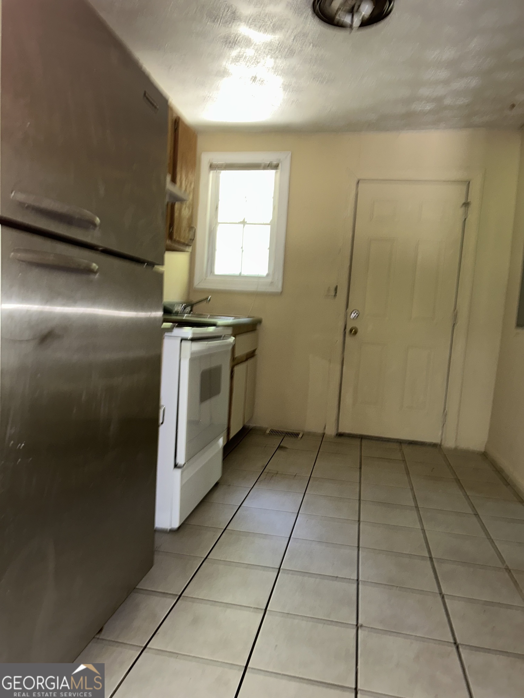 118 Tye Street Stockbridge, GA 30281 - Photo 8 of 12 a kitchen with a cabinets and a stove