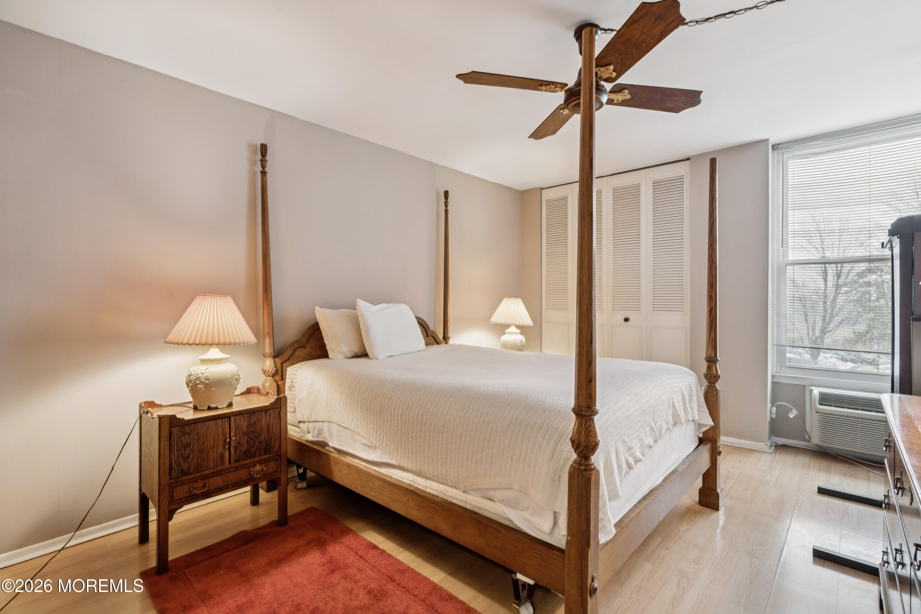 11 River Road, Unit 11L Nutley, NJ 07110 - Photo 15 of 26 a bed room with a bed and a chandelier