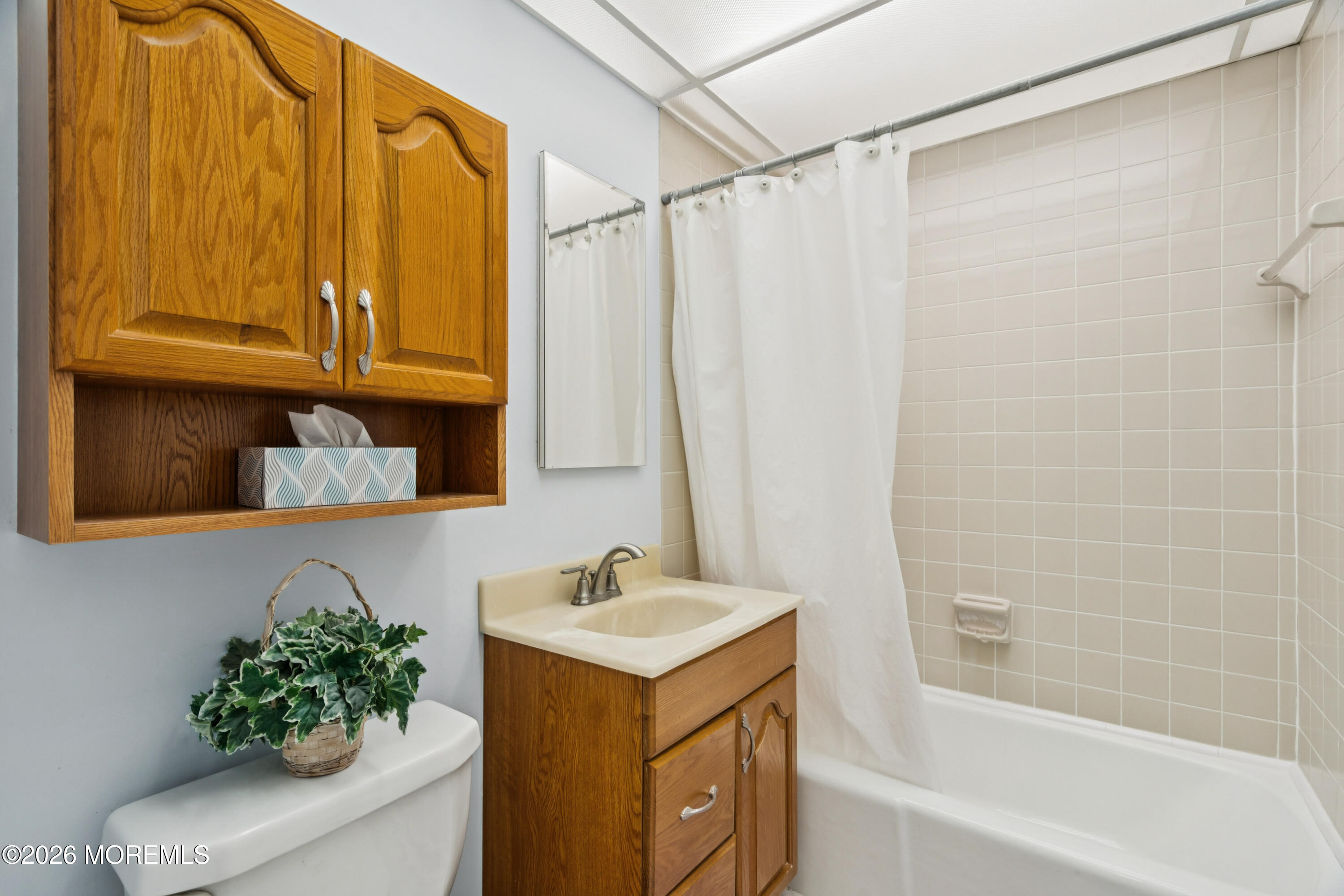11 River Road, Unit 11L Nutley, NJ 07110 - Photo 18 of 26 a bathroom with a shower curtain and a sink