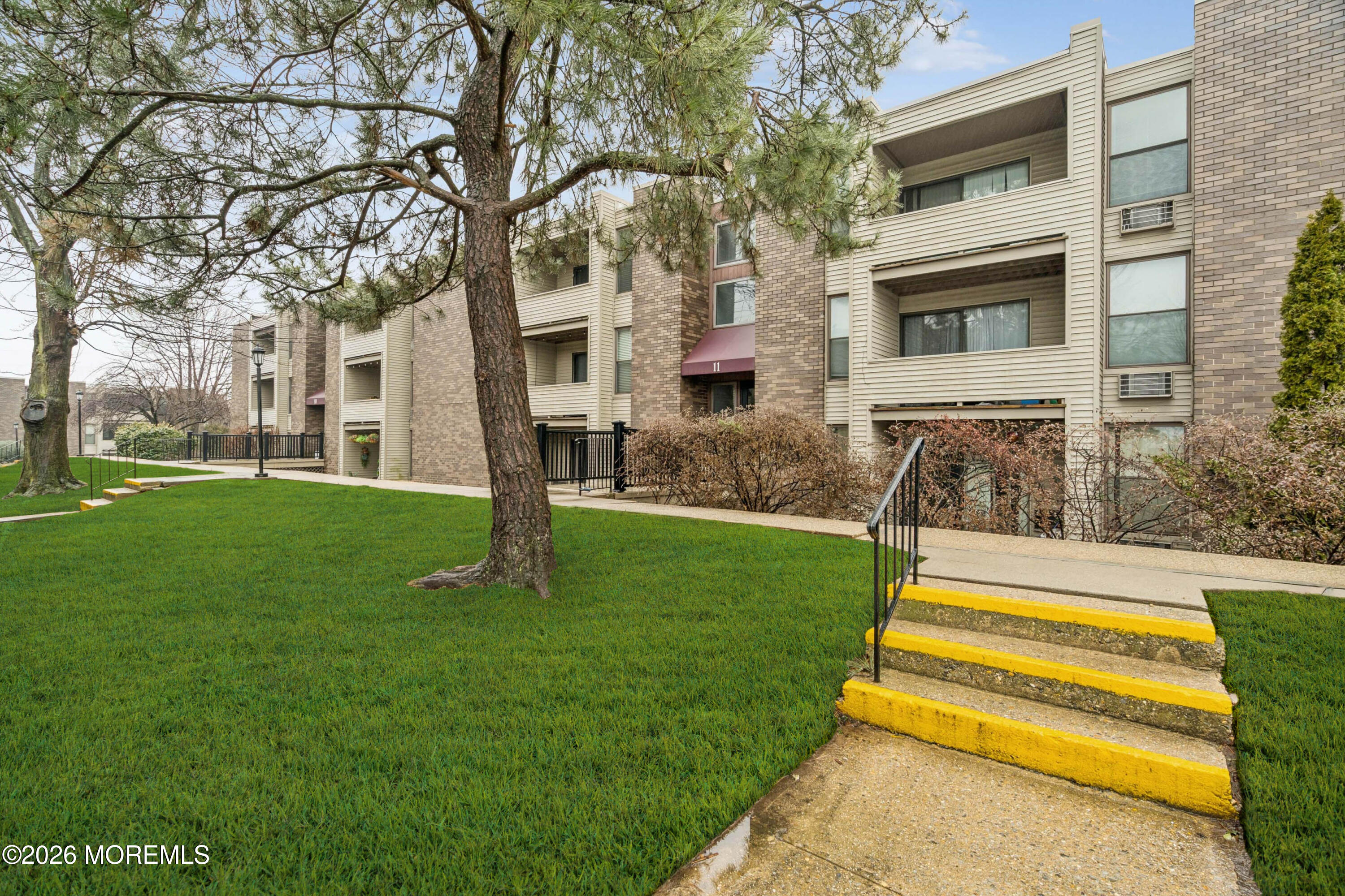 11 River Road, Unit 11L Nutley, NJ 07110 - Photo 21 of 26 a garden with trees in front of it
