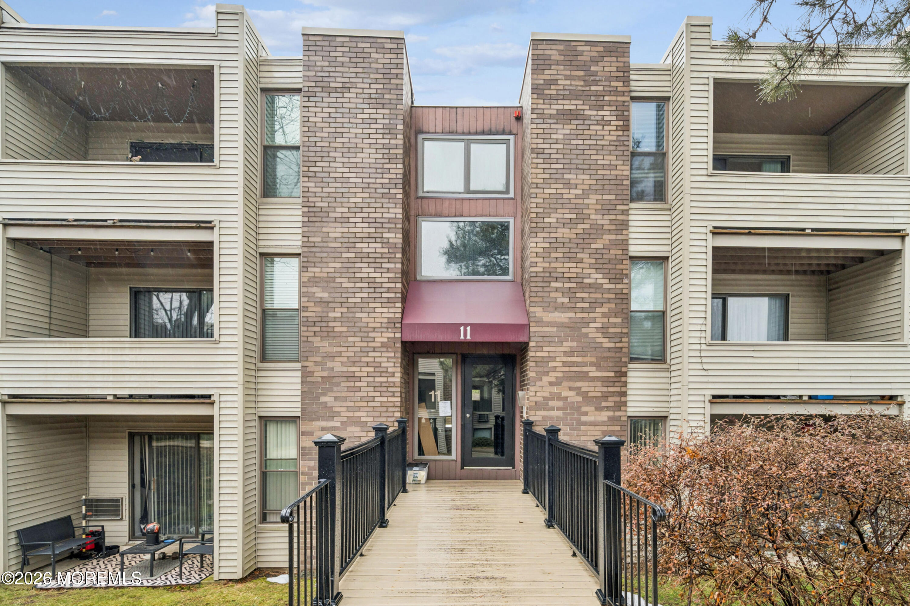 11 River Road, Unit 11L Nutley, NJ 07110 - Photo 23 of 26 a view of a brick house with large windows