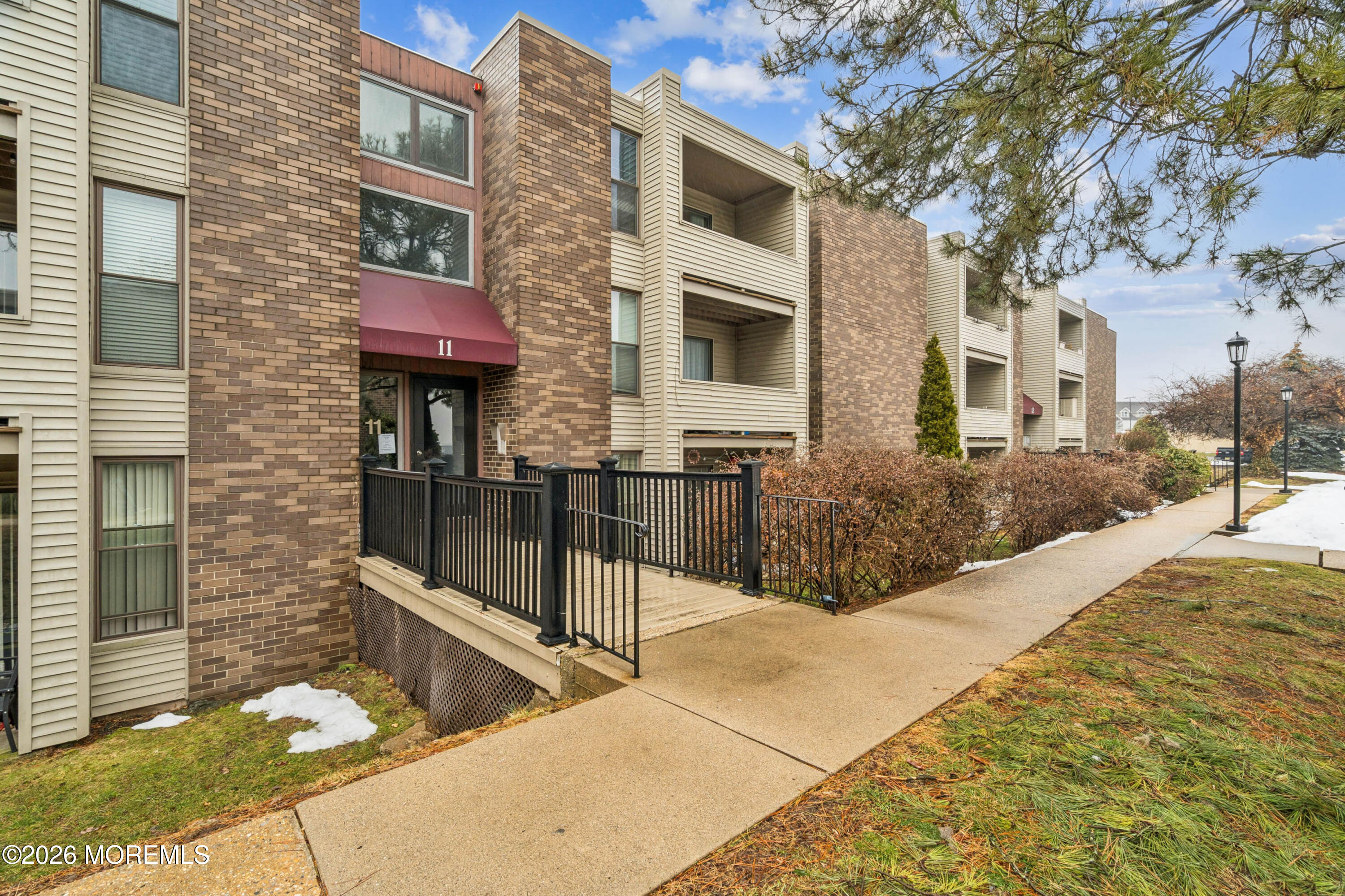 11 River Road, Unit 11L Nutley, NJ 07110 - Photo 25 of 26 a view of a brick house with many windows