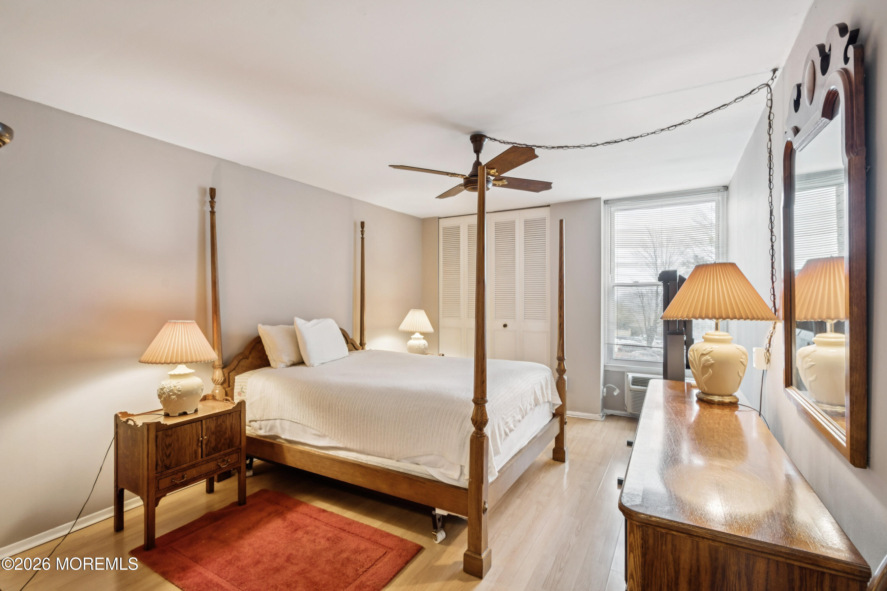 11 River Road, Unit 11L Nutley, NJ 07110 - Photo 4 of 26 a bedroom with a bed window and table