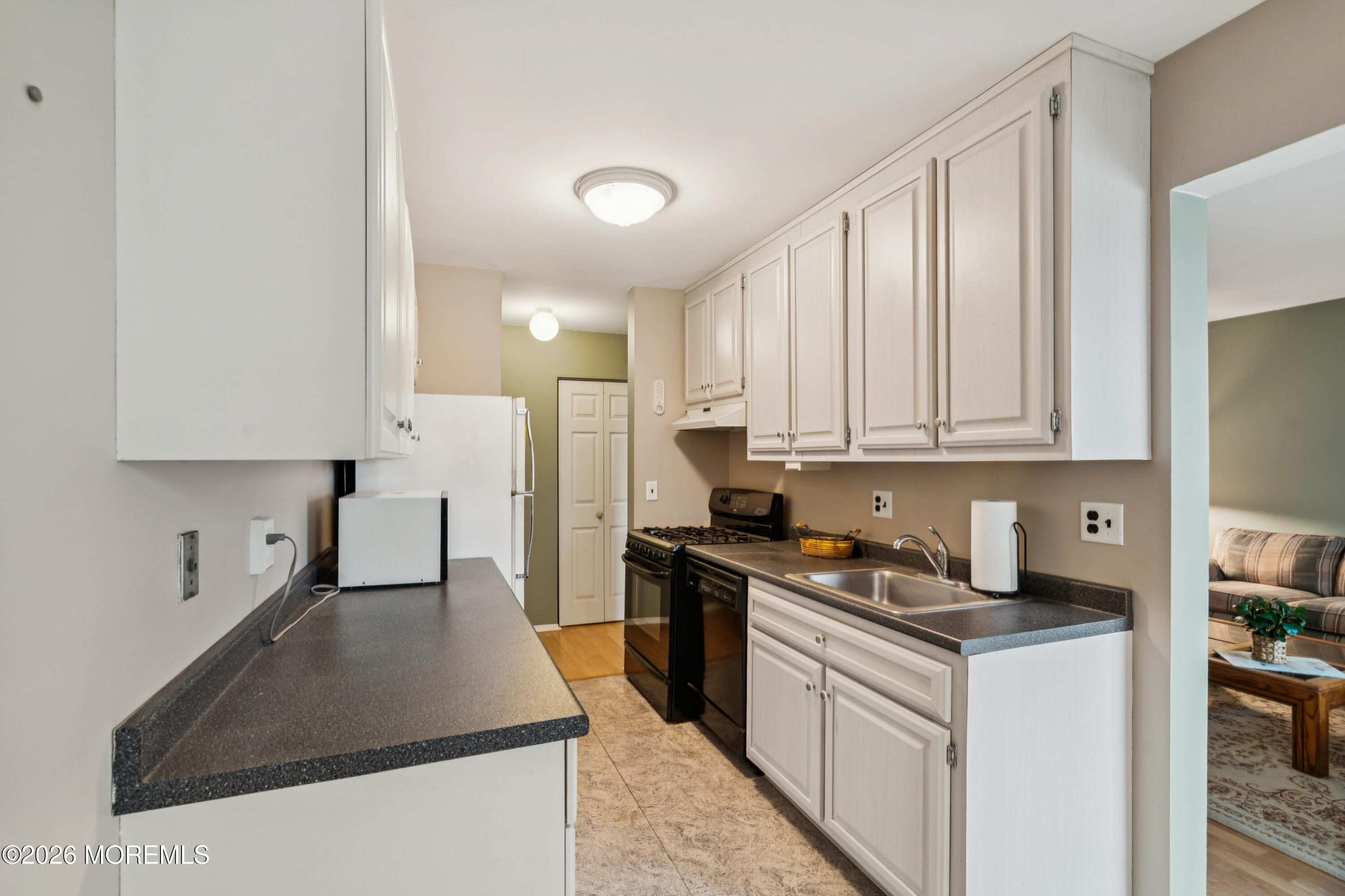 11 River Road, Unit 11L Nutley, NJ 07110 - Photo 5 of 26 a kitchen with stainless steel appliances granite countertop a stove a sink a refrigerator and white cabinets