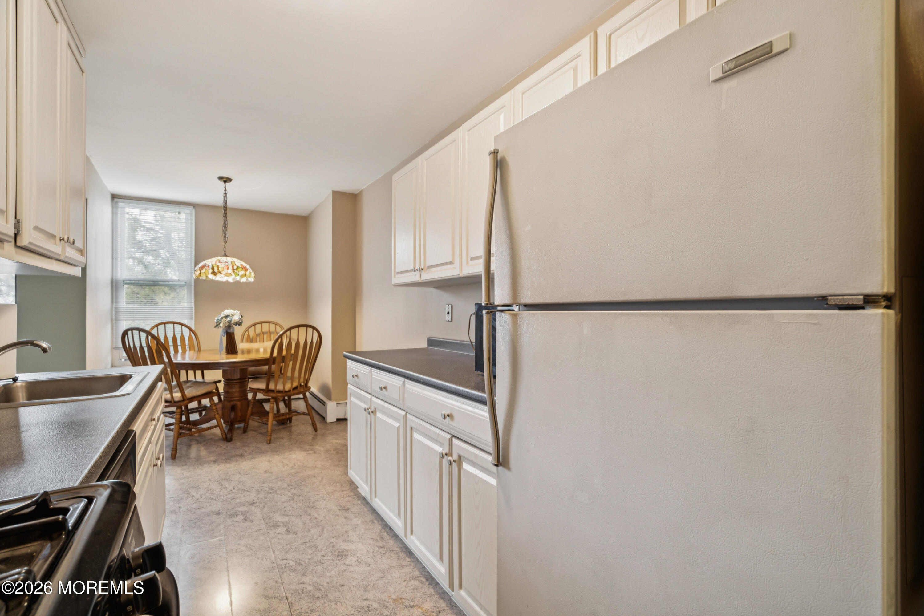 11 River Road, Unit 11L Nutley, NJ 07110 - Photo 7 of 26 a dining room with furniture and window