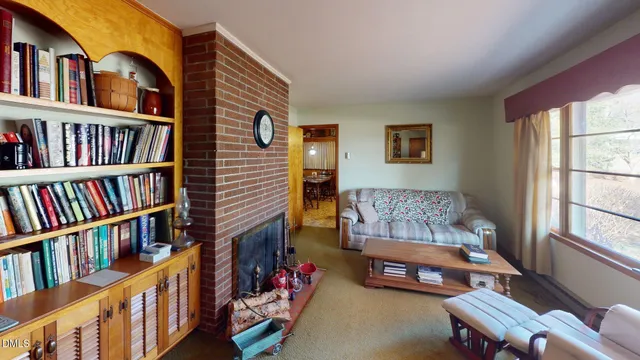 a living room with furniture and a book shelf