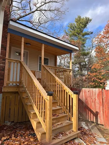 a view of balcony with wooden floor and fence
