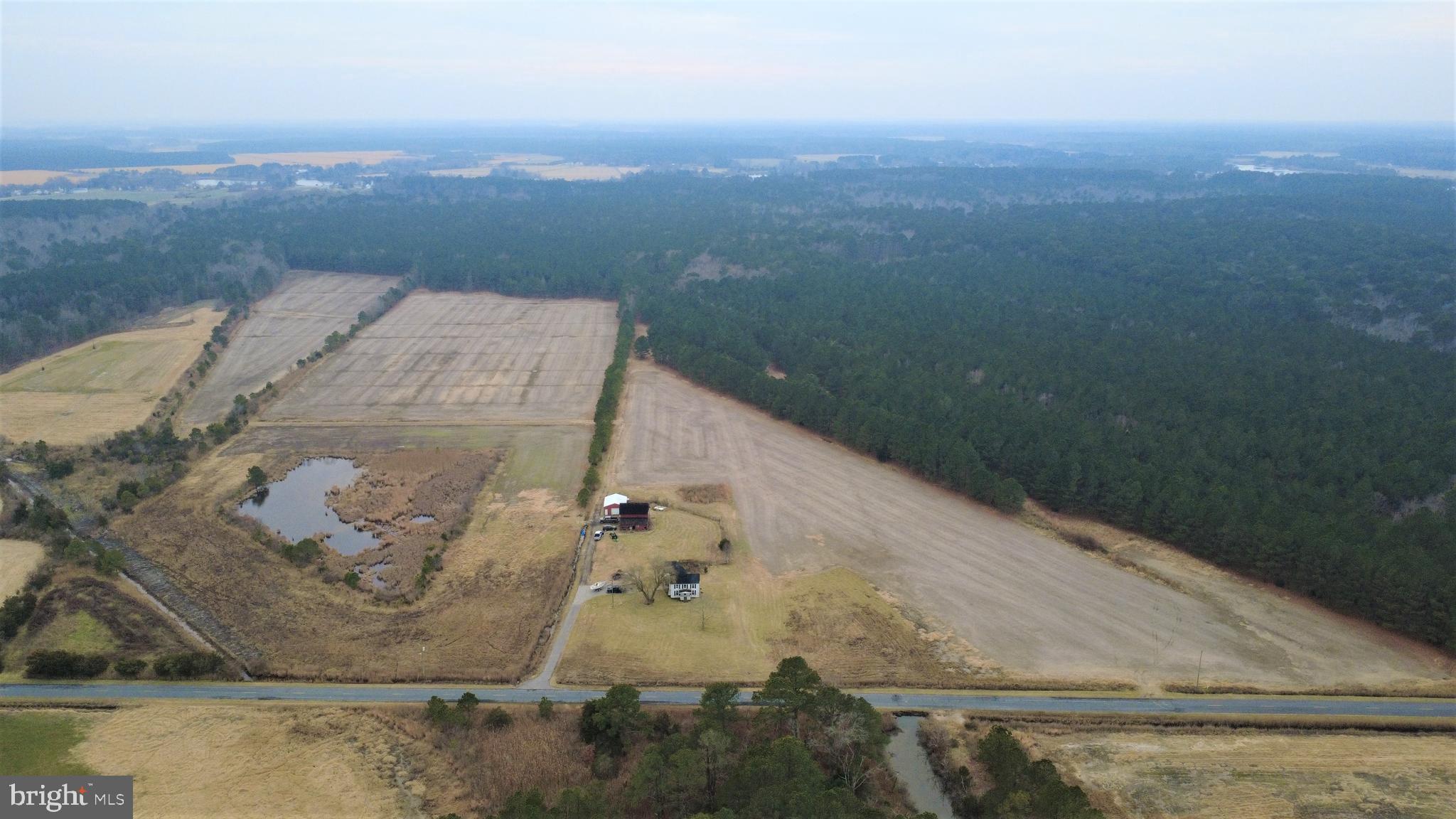 1829 Brannock Neck Road Cambridge, MD 21613 - Photo 1 of 55 an aerial view of a house with a yard and mountain in the back