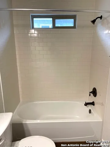 a bathroom with a shower and a toilet