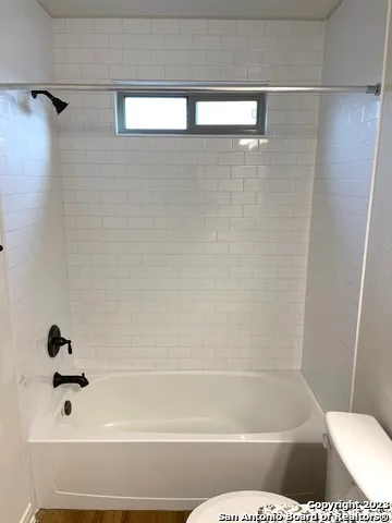 a bathroom with a shower and toilet