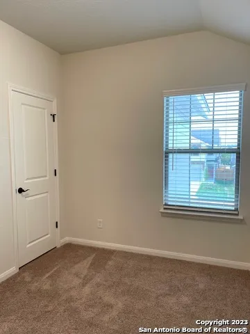 a view of an empty room with a window
