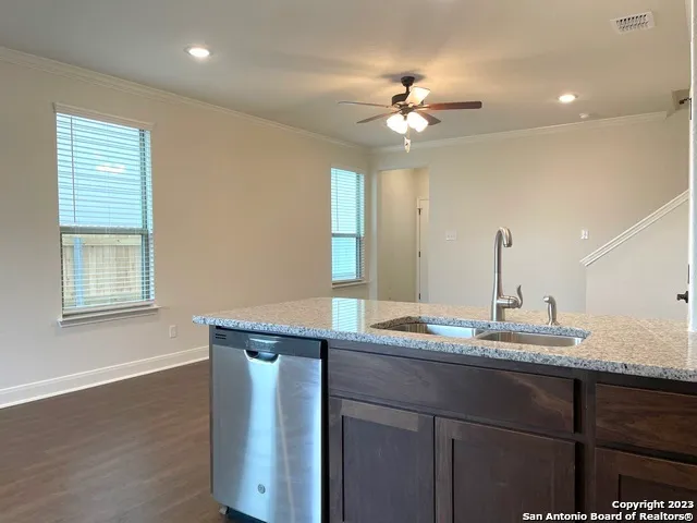a bathroom with a granite countertop sink a light fixture and a mirror