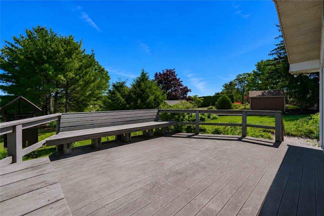 4815 Mill Road Schnecksville, PA 18078 - Photo 39 of 48 A spacious outdoor deck with integrated seating, offering serene views of the surrounding verdant landscape.