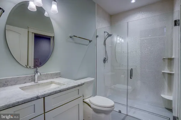 a bedroom with a large bed a potted plant and a window