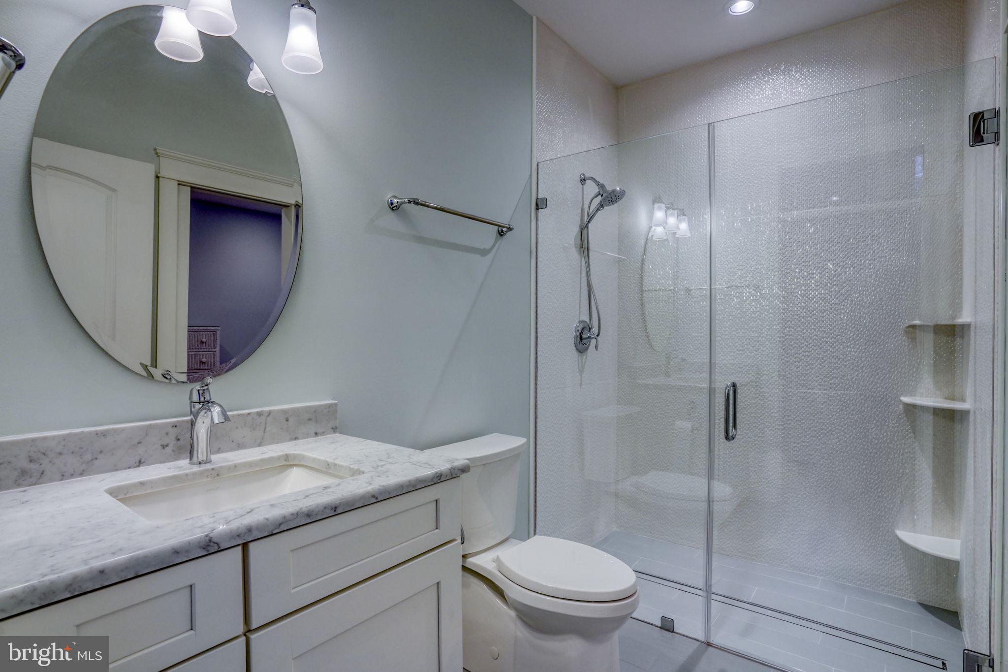 237 2nd Street Lewes, DE 19958 - Photo 12 of 52 a bathroom with a granite countertop sink toilet and shower