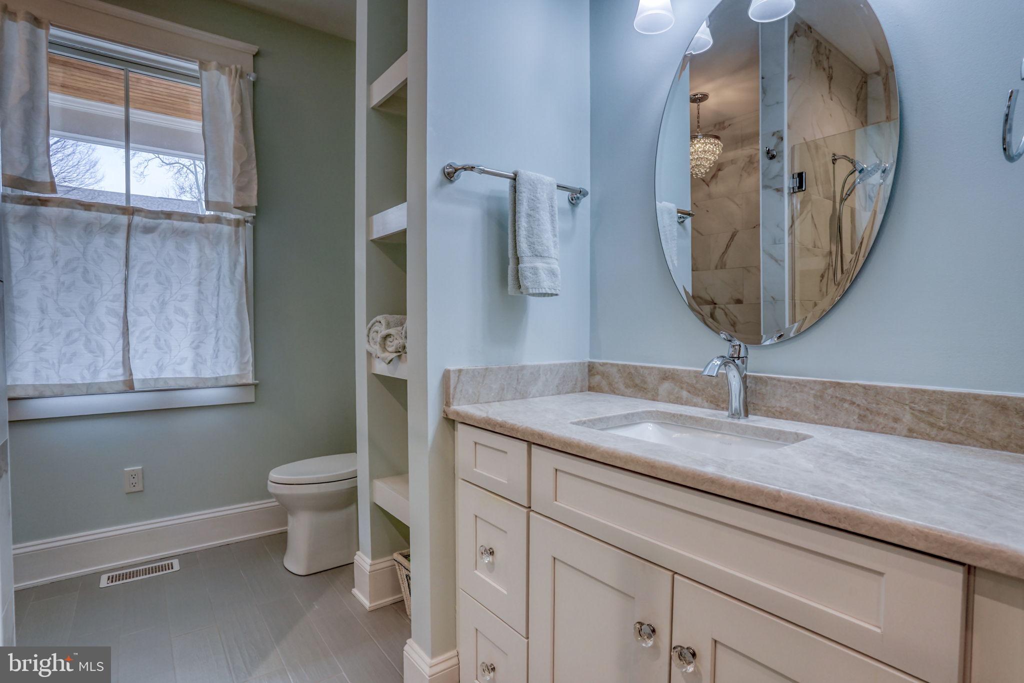 237 2nd Street Lewes, DE 19958 - Photo 14 of 52 a bathroom with a granite countertop sink and a mirror