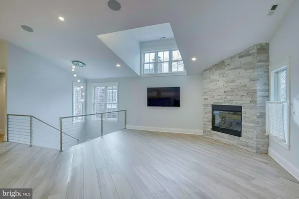 a kitchen with a dining table a chandelier and wooden floor