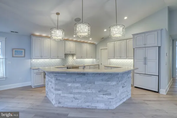 a kitchen with a sink appliances and cabinets