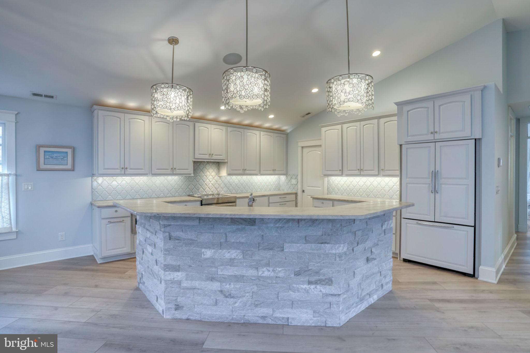 237 2nd Street Lewes, DE 19958 - Photo 23 of 52 a large kitchen with kitchen island stainless steel appliances a chandelier and wooden floor