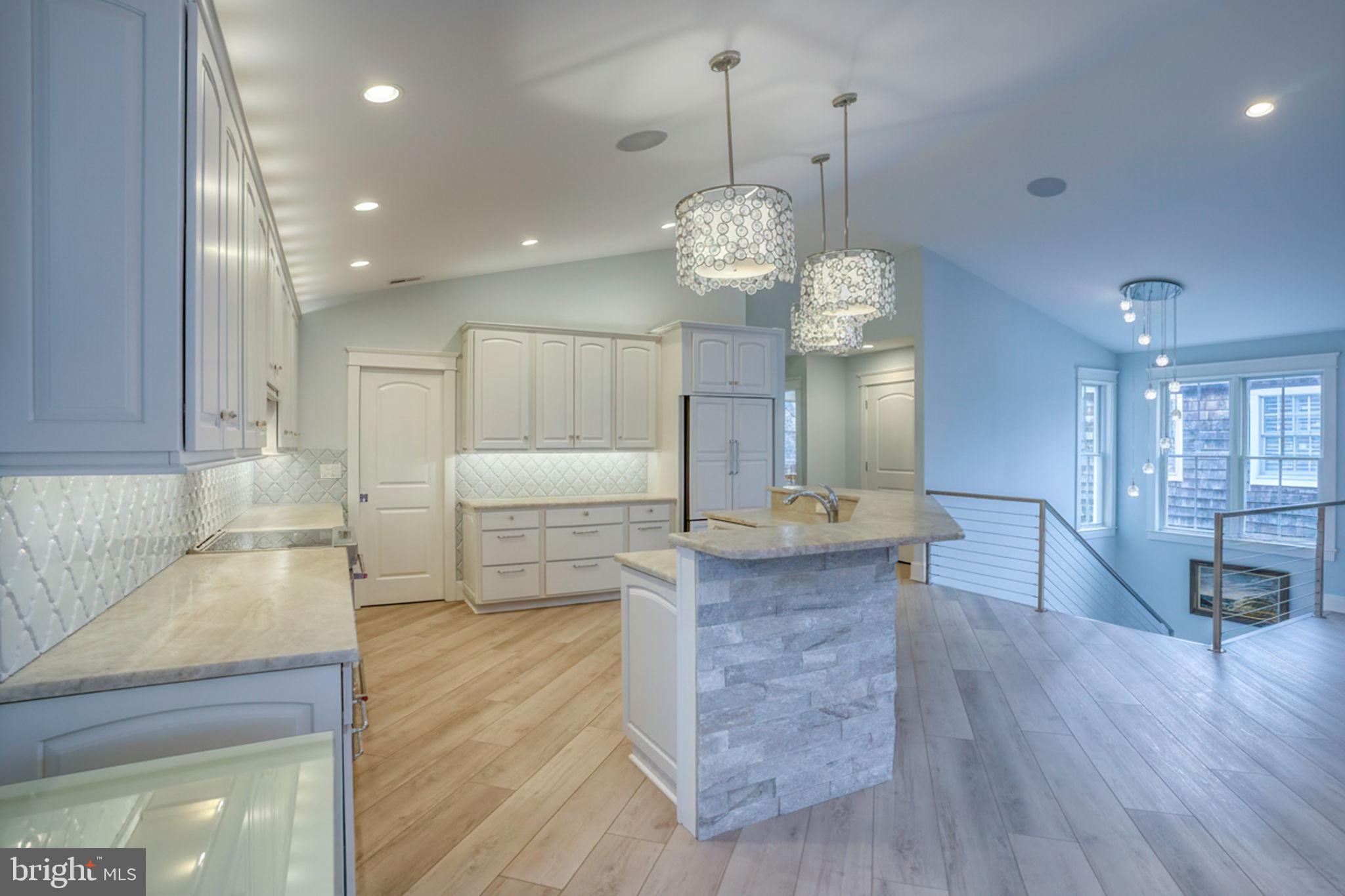 237 2nd Street Lewes, DE 19958 - Photo 26 of 52 a large kitchen with stainless steel appliances granite countertop a large kitchen island a stove and a wooden floors