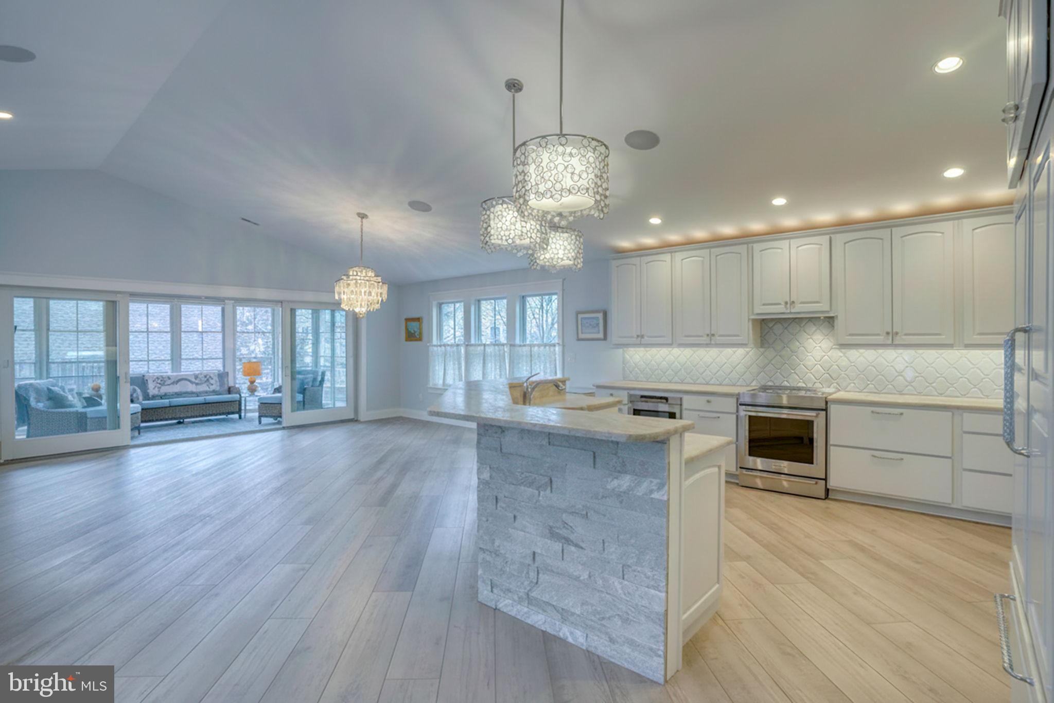237 2nd Street Lewes, DE 19958 - Photo 27 of 52 a large kitchen with stainless steel appliances granite countertop a oven a stove and a wooden floors