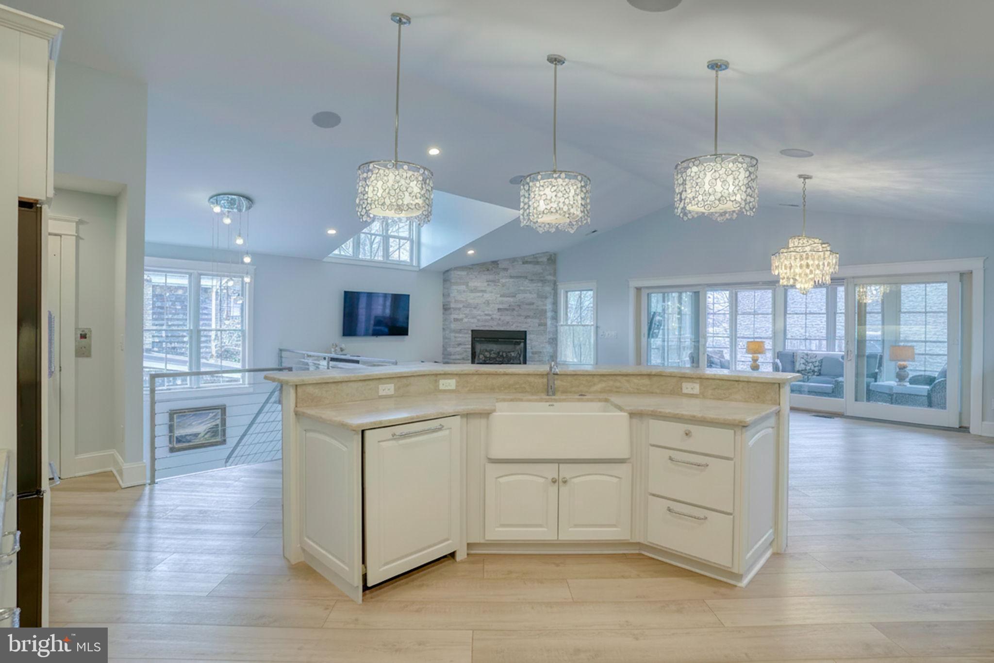 237 2nd Street Lewes, DE 19958 - Photo 29 of 52 a large kitchen with white cabinets and stainless steel appliances