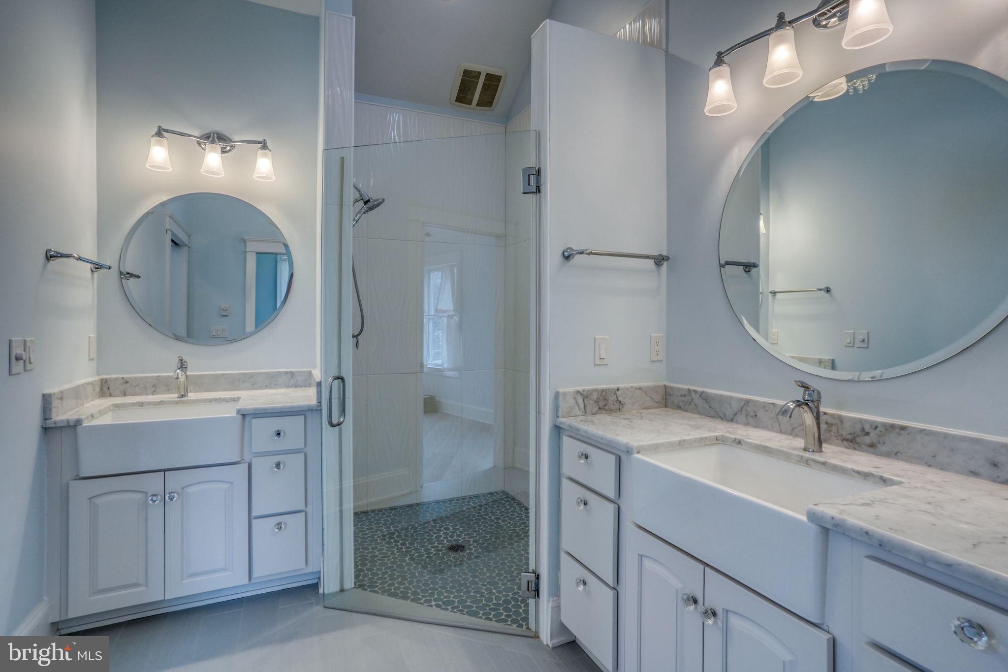 237 2nd Street Lewes, DE 19958 - Photo 35 of 52 a bathroom with a double vanity sink mirror and shower