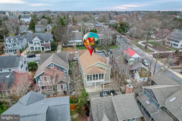 an aerial view of a house with a mountain