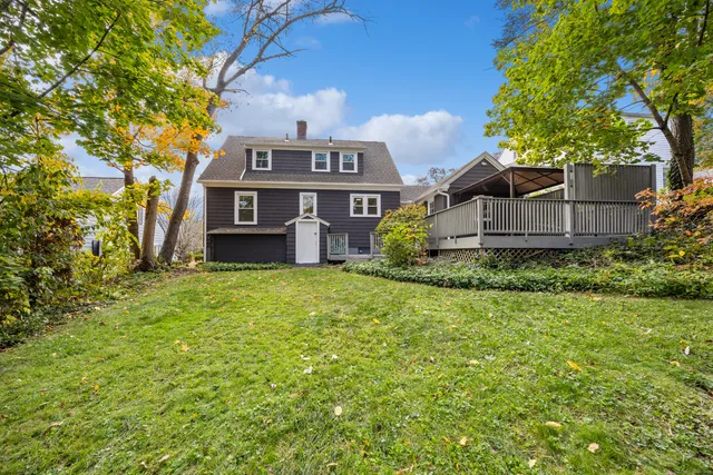 a front view of a house with a garden