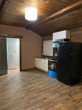 a kitchen with stainless steel appliances a refrigerator and a stove
