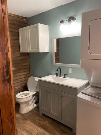 a bathroom with a toilet sink and mirror