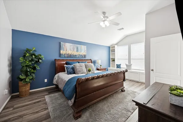 a bedroom with a large bed and a chandelier