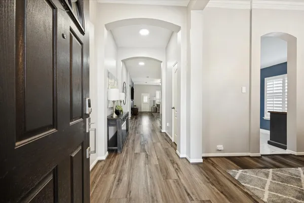 a view of a hallway view with wooden floor and staircase