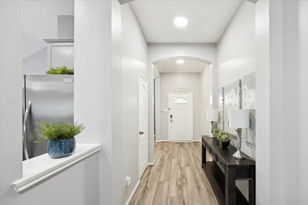 a view of a hallway and a livingroom with furniture