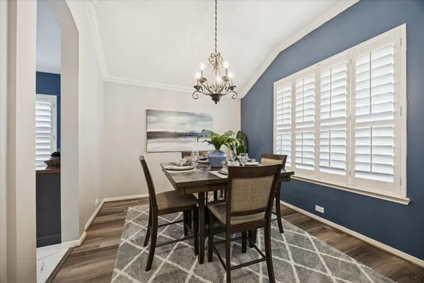 a dining room with furniture a chandelier and window