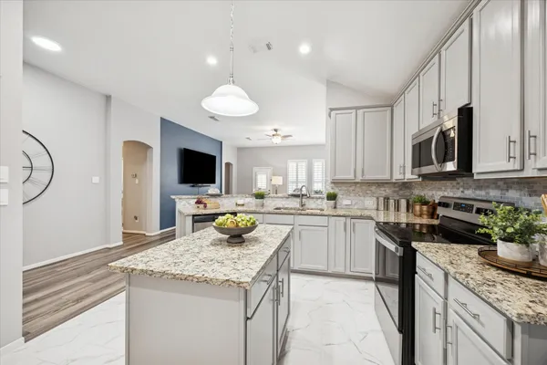 a kitchen with a sink stove and microwave