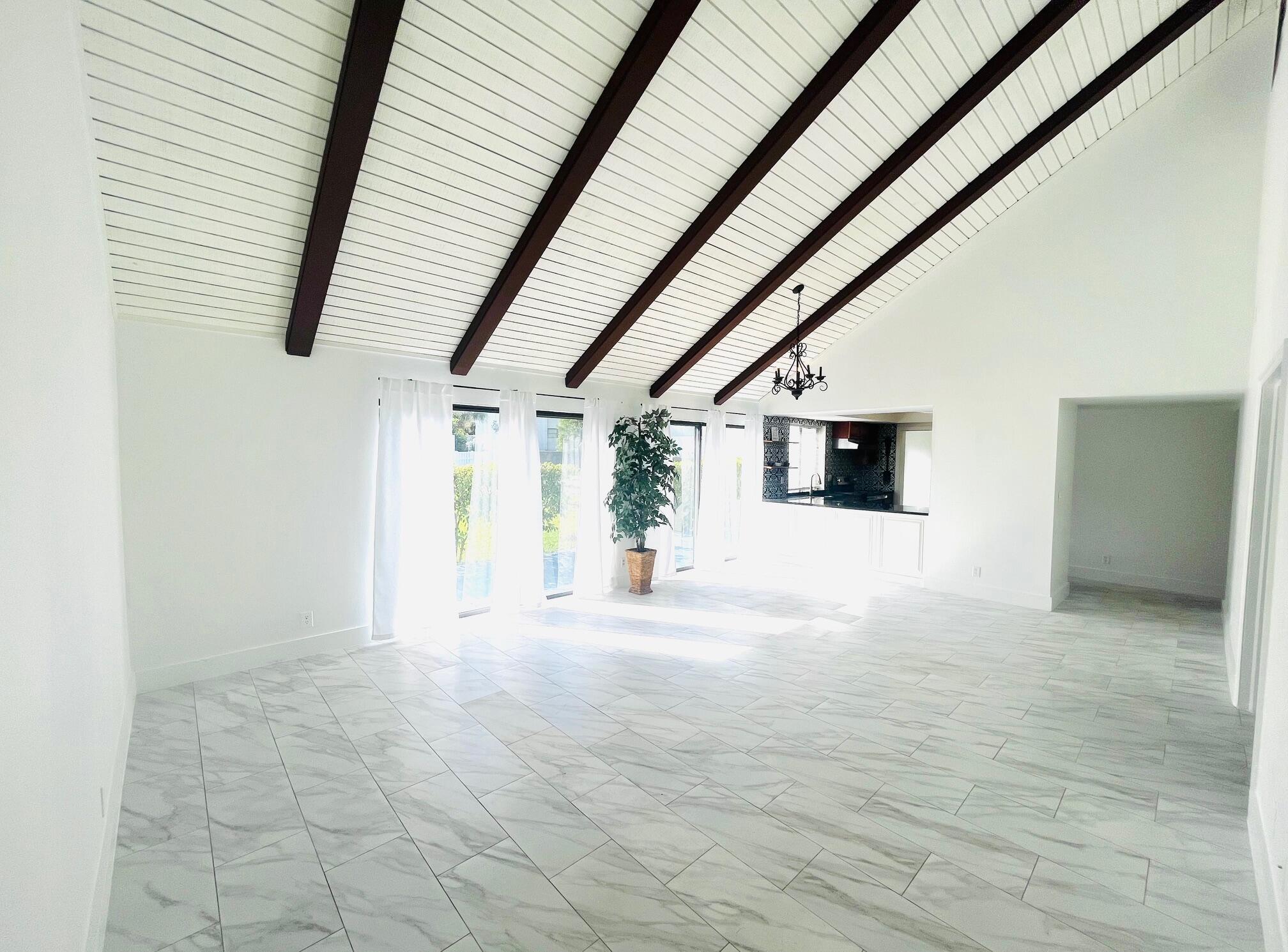 a view of a livingroom with wooden floor and stairs