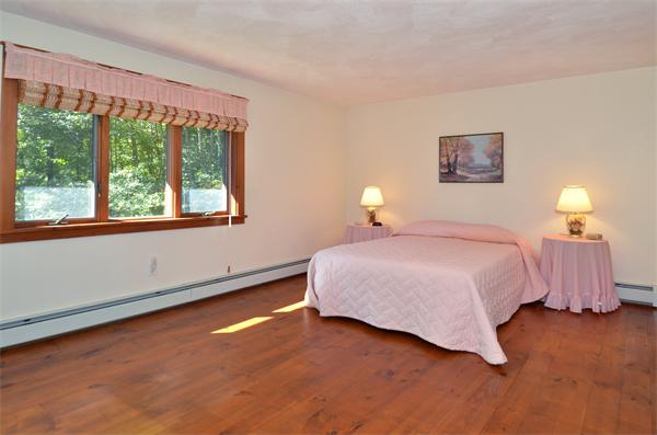 56 Baldpate Road Georgetown, MA 01833 - Photo 18 of 30 a spacious bedroom with a bed and a window