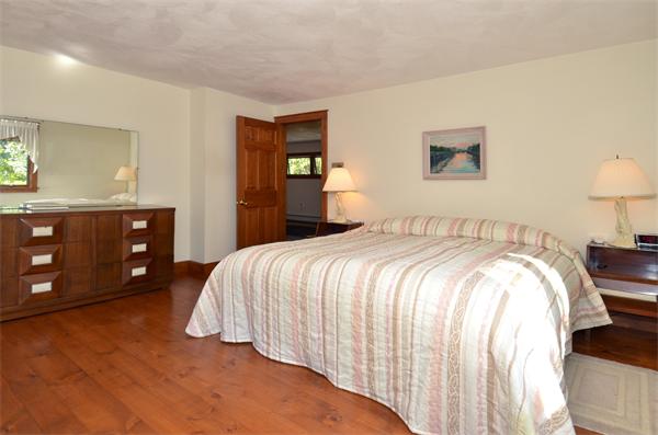 56 Baldpate Road Georgetown, MA 01833 - Photo 21 of 30 a bedroom with a bed and a lamp on dresser