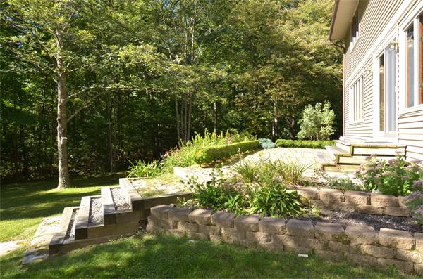 56 Baldpate Road Georgetown, MA 01833 - Photo 25 of 30 a view of a garden with a bench